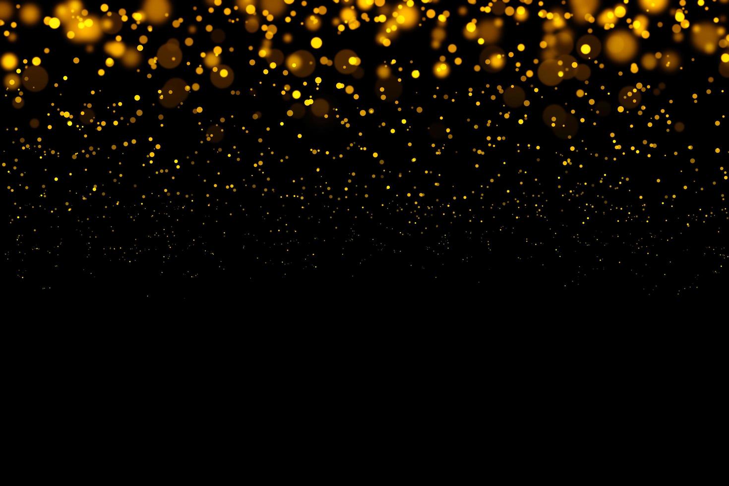 Blurred gold circles on black background photo