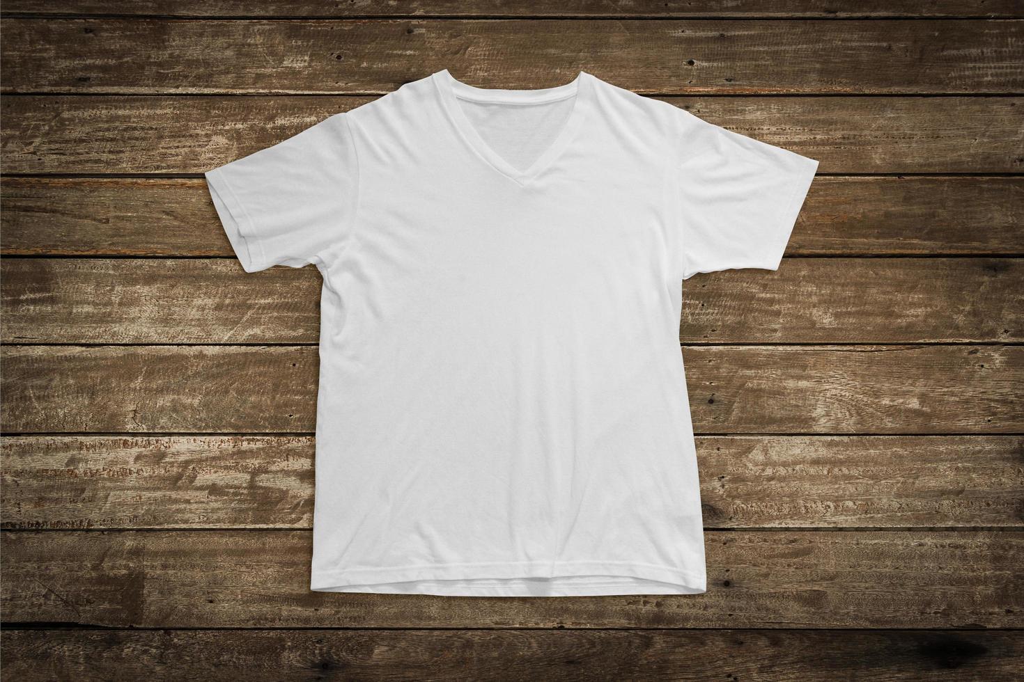 White t-shirt on wood background for mockup template photo