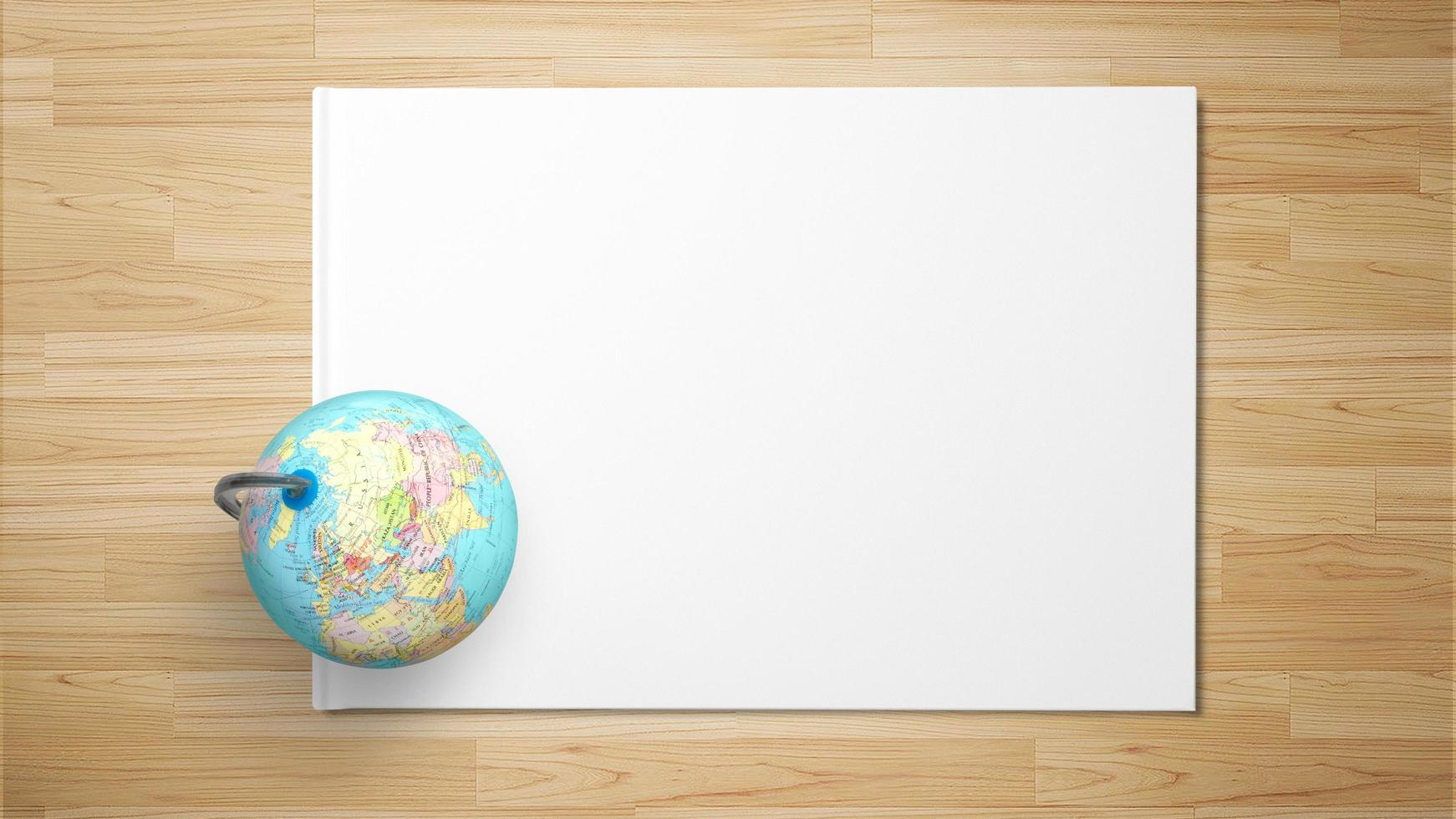Globe on paper on wooden background photo
