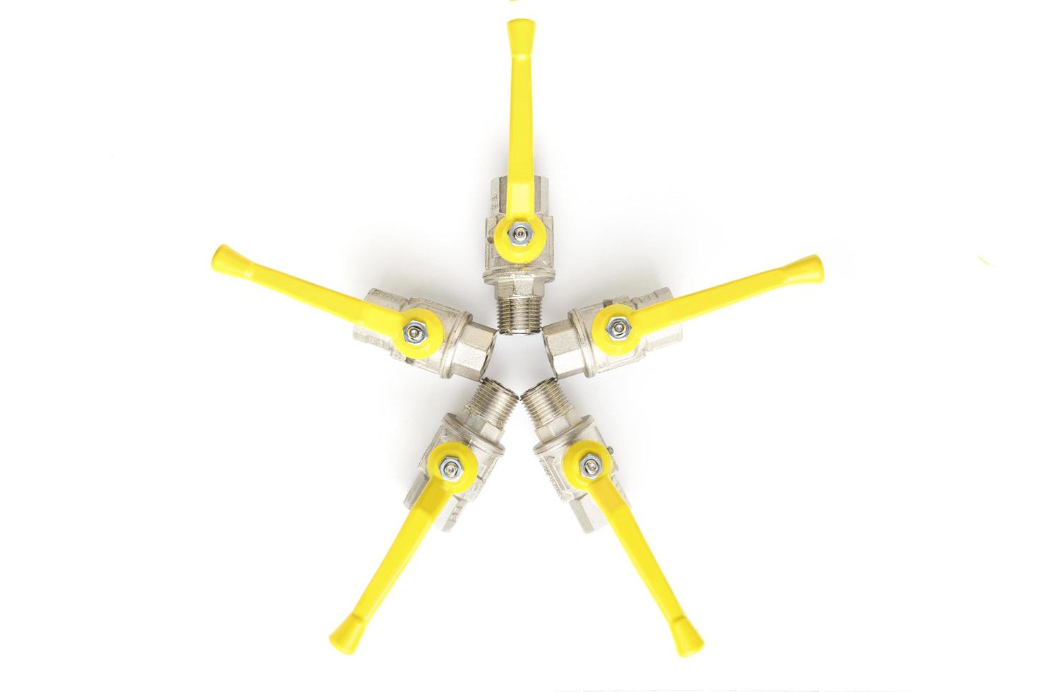 Top view of set of faucets with yellow levers on white background photo