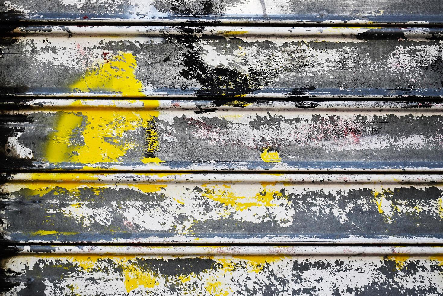 Detail of colorful spray painted metal roll up door photo