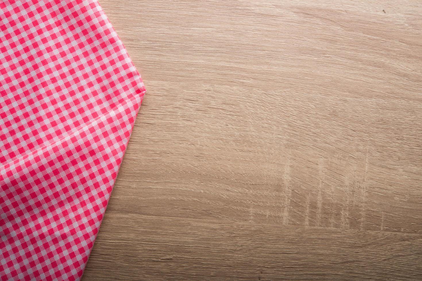 Checkered red napkin on wooden background photo