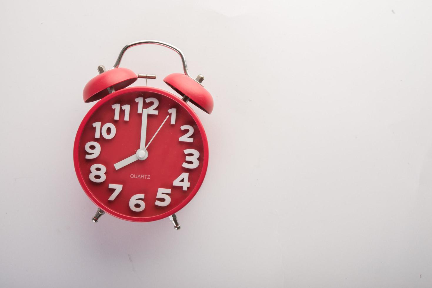 Red alarm clock isolated on a white background photo