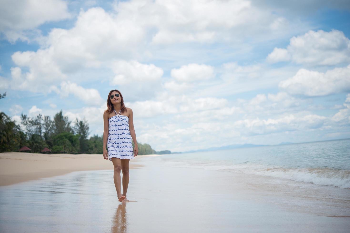 Young beautiful happy woman enjoying the beach photo