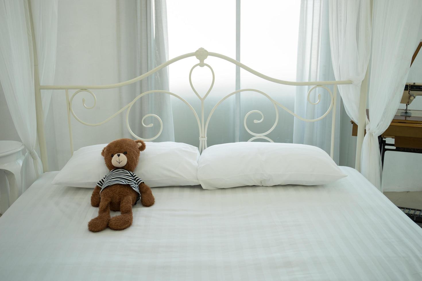 Cute teddy bear in a white room photo