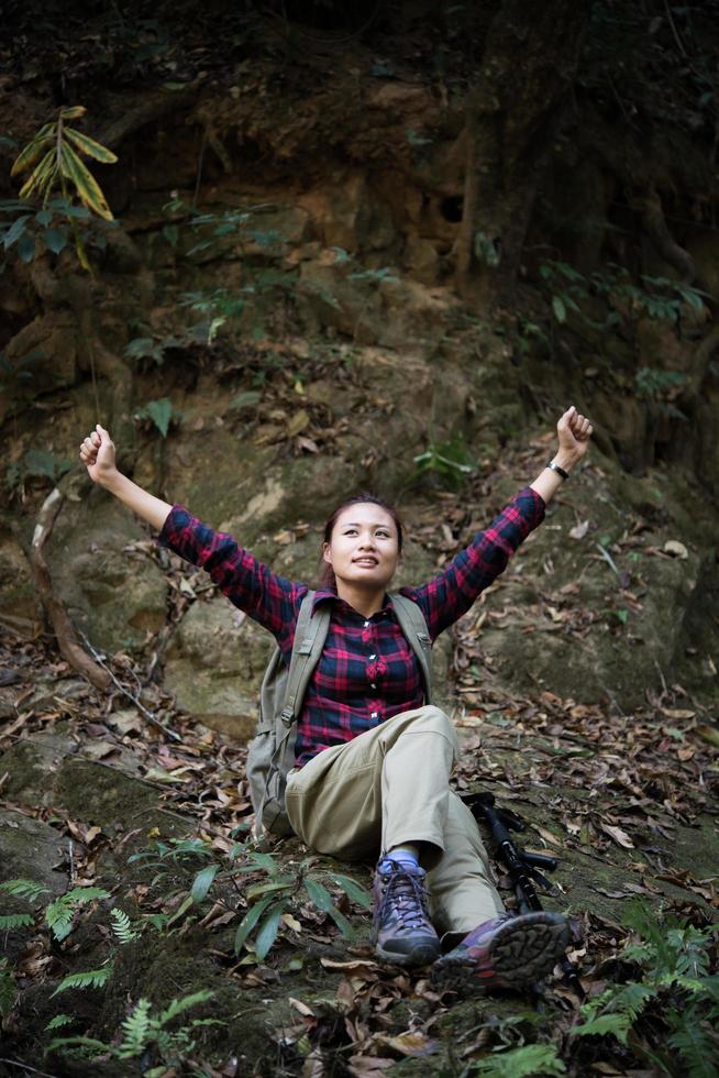 Woman hiker in forest taking a rest photo