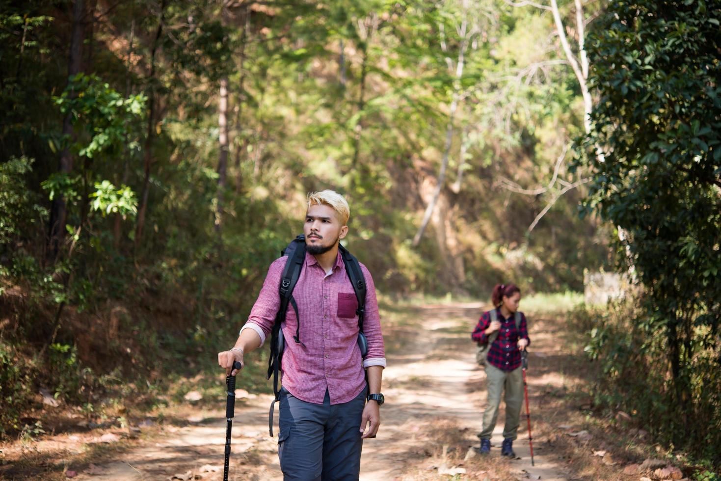 Backpackers couple hiking outdoors photo