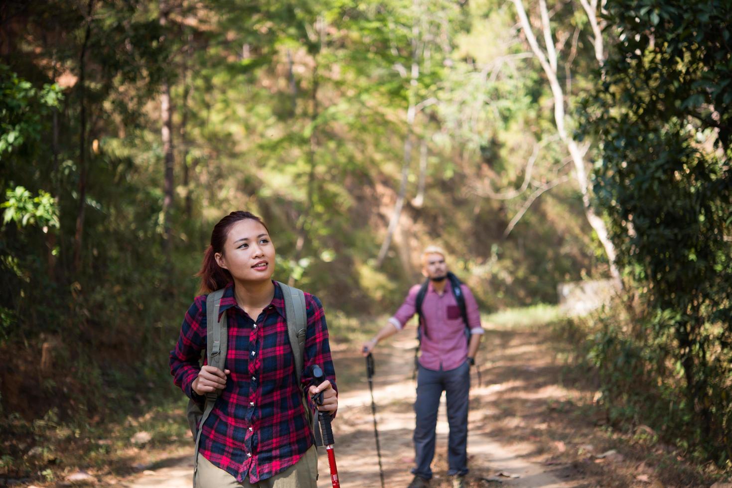 Backpackers couple hiking together photo