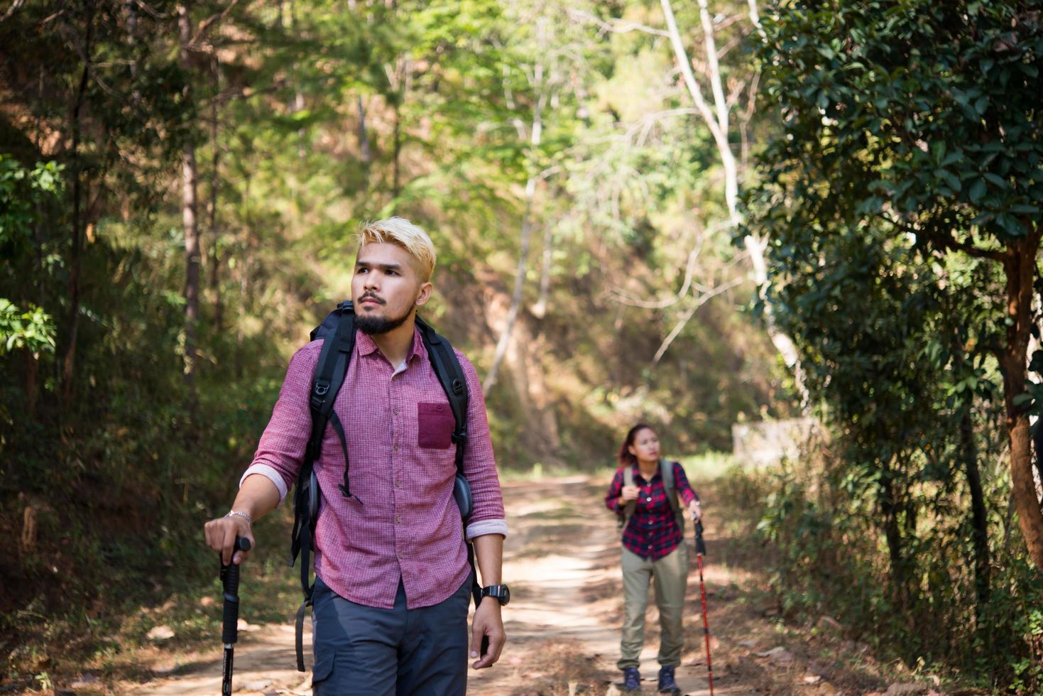 Backpackers couple hiking together photo