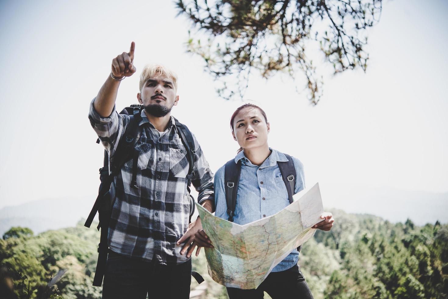 Young adventure couple hiking to a mountain photo