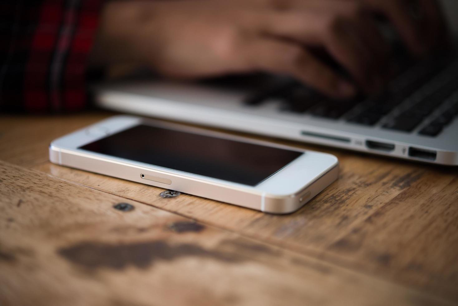 Close-up of young hipster woman using a laptop during a coffee break photo