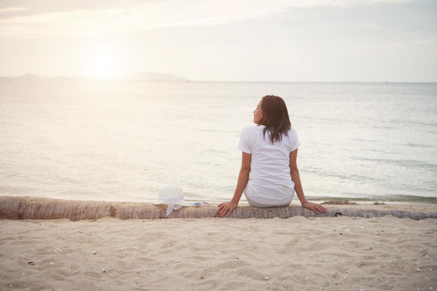 Young beautiful woman relaxing at the beach photo