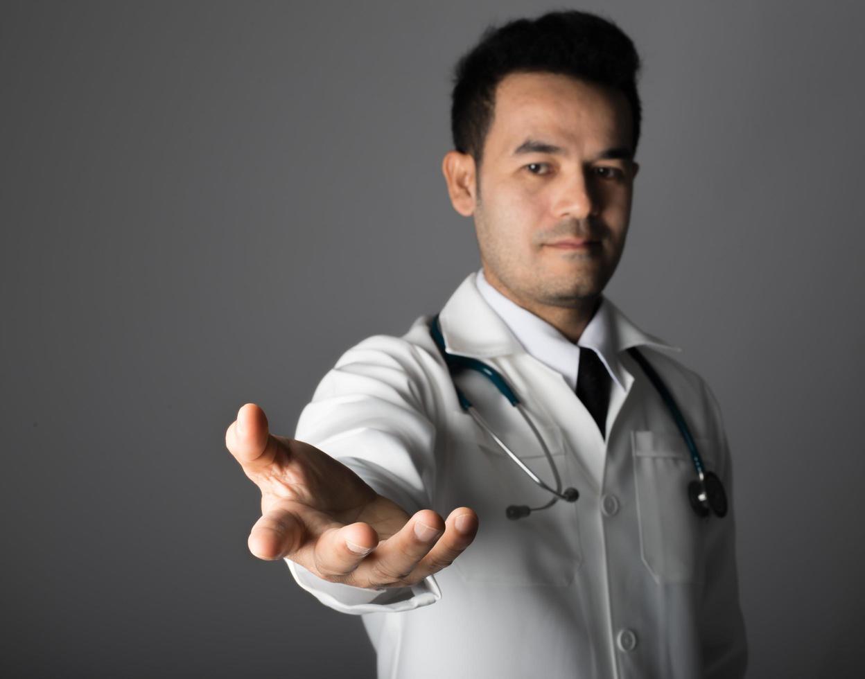 Medical doctor with a stethoscope and empty hand photo