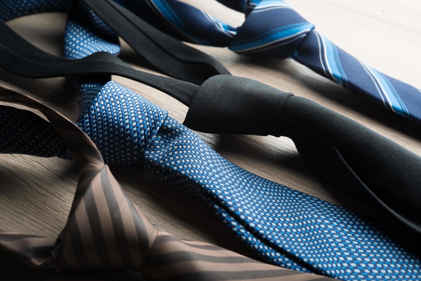 Silk neck ties on a wooden background photo