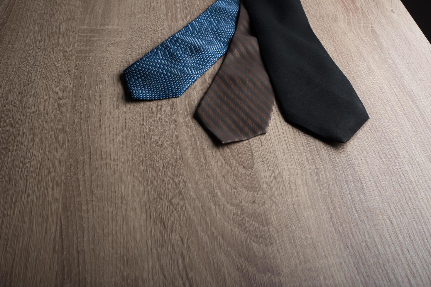 Silk neck ties on a wooden background photo