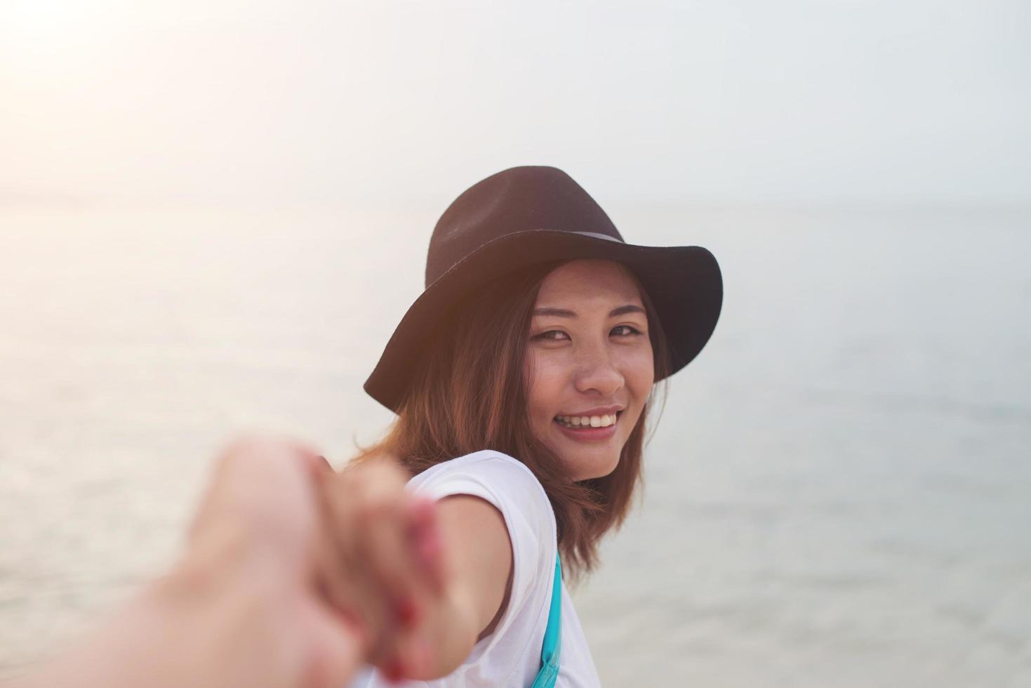 Happy young woman on vacation at the beach photo