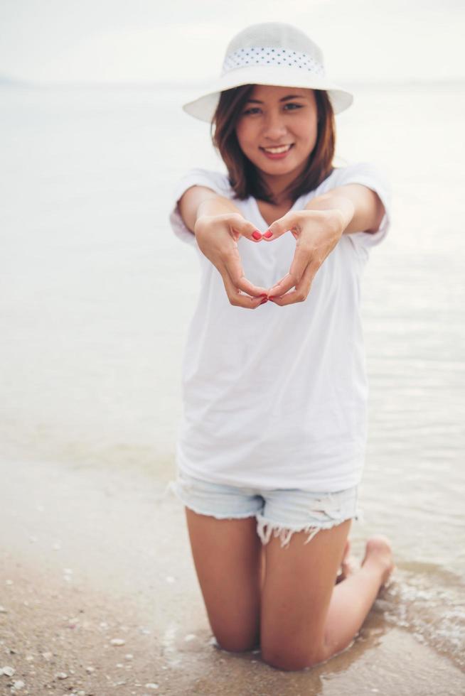 Happy young woman on vacation at the beach photo