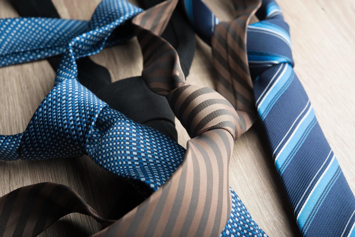 Silk neck ties on a wooden background photo