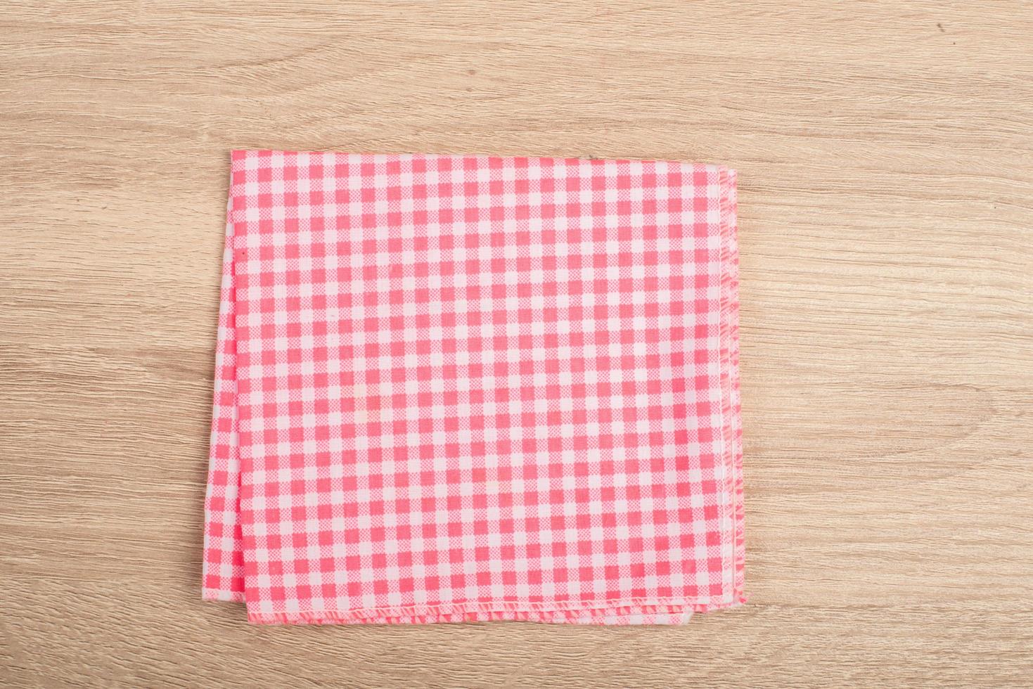 Red table napkin isolated on background photo