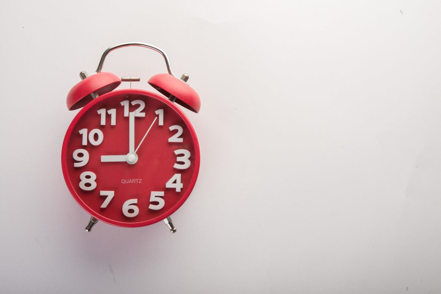 Red alarm clock isolated on white background photo