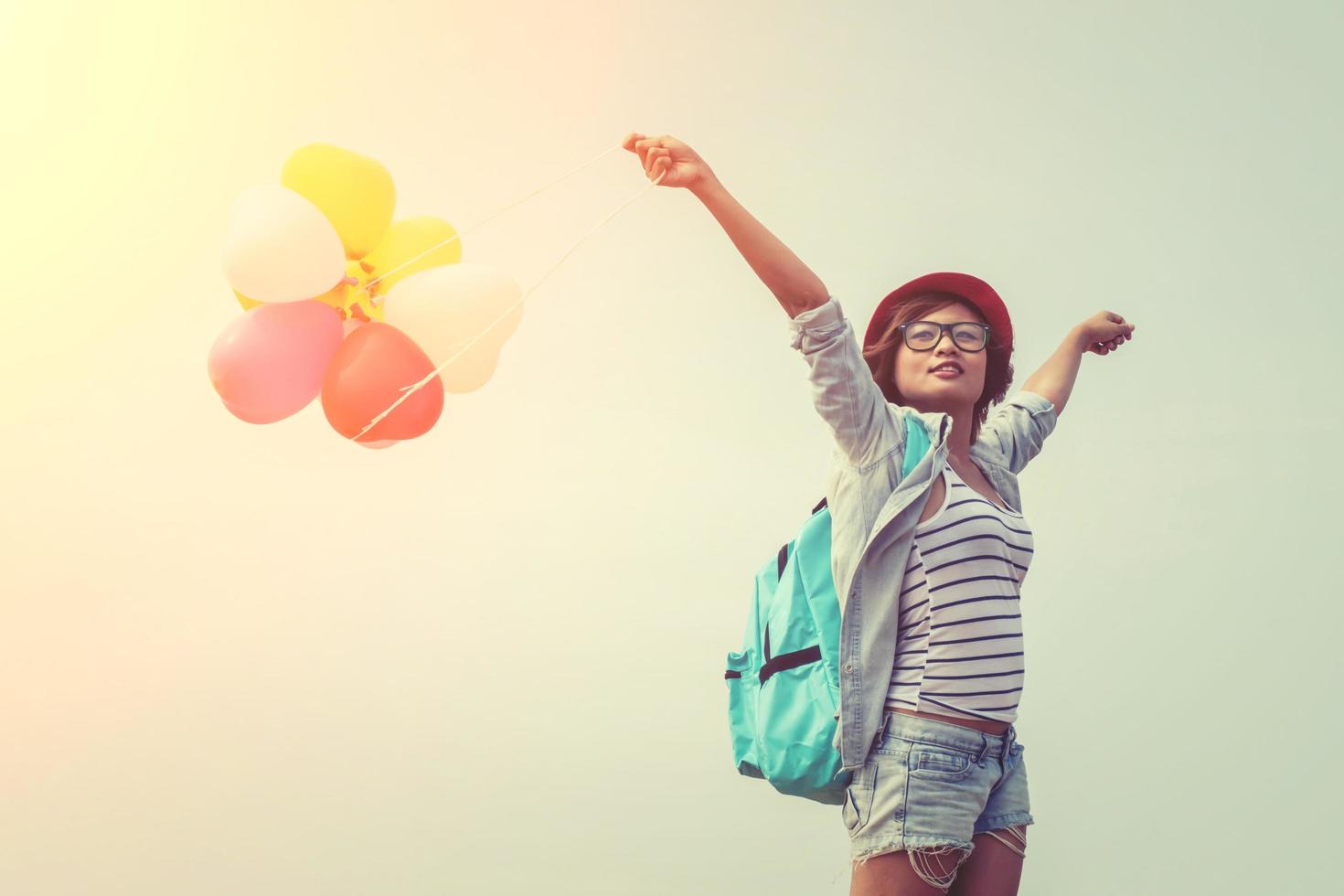 Teenage girl holding colorful balloons photo