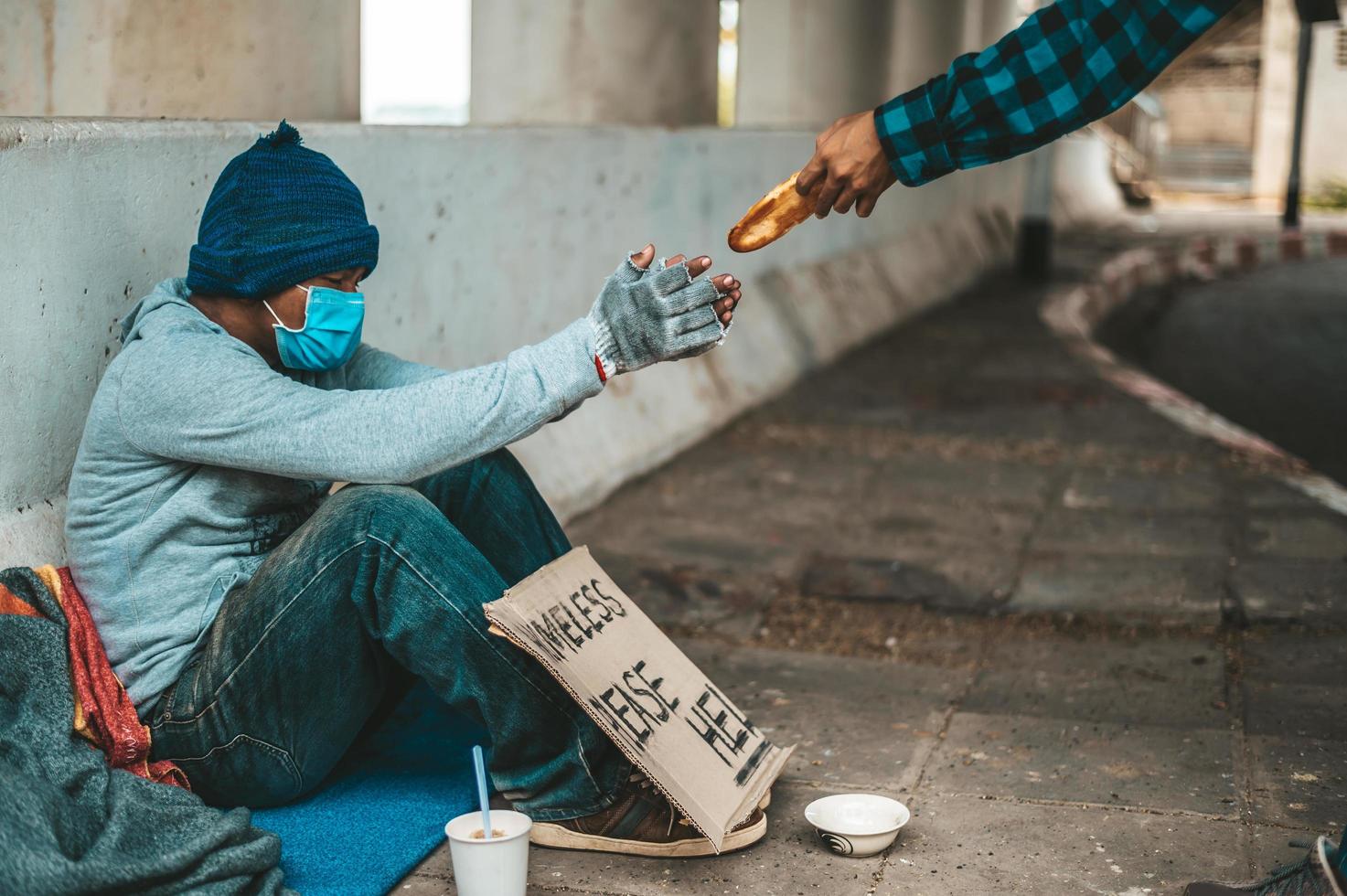 Bread maker gives to a beggar on the side of the road photo