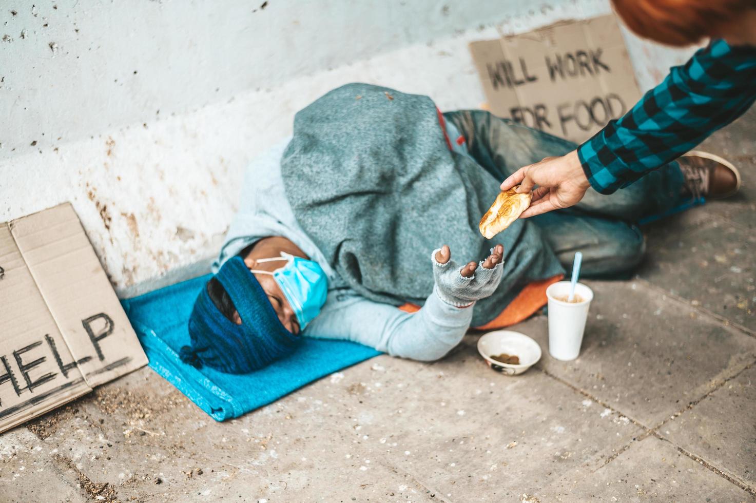 Bread maker gives to a beggar on the side of the road photo