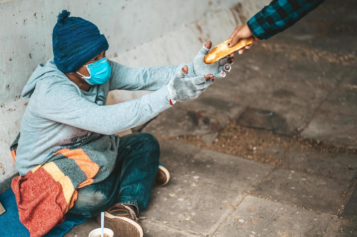 Bread maker gives to a beggar on the side of the road photo