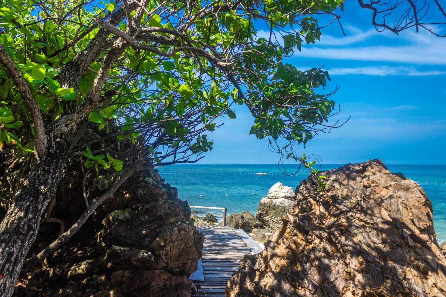 Tropical island rock on the beach with cloudy blue sky photo