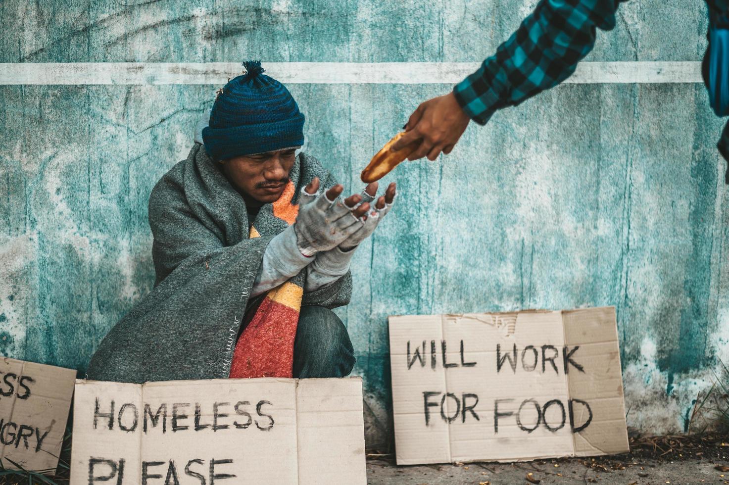 Bread makers give to the beggar on the side of the road photo