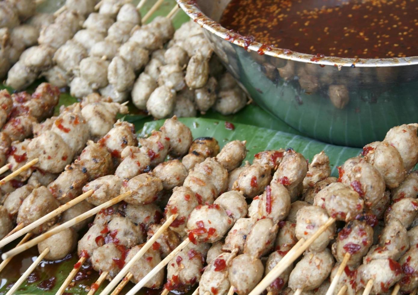 Pork on sticks with dipping sauce photo
