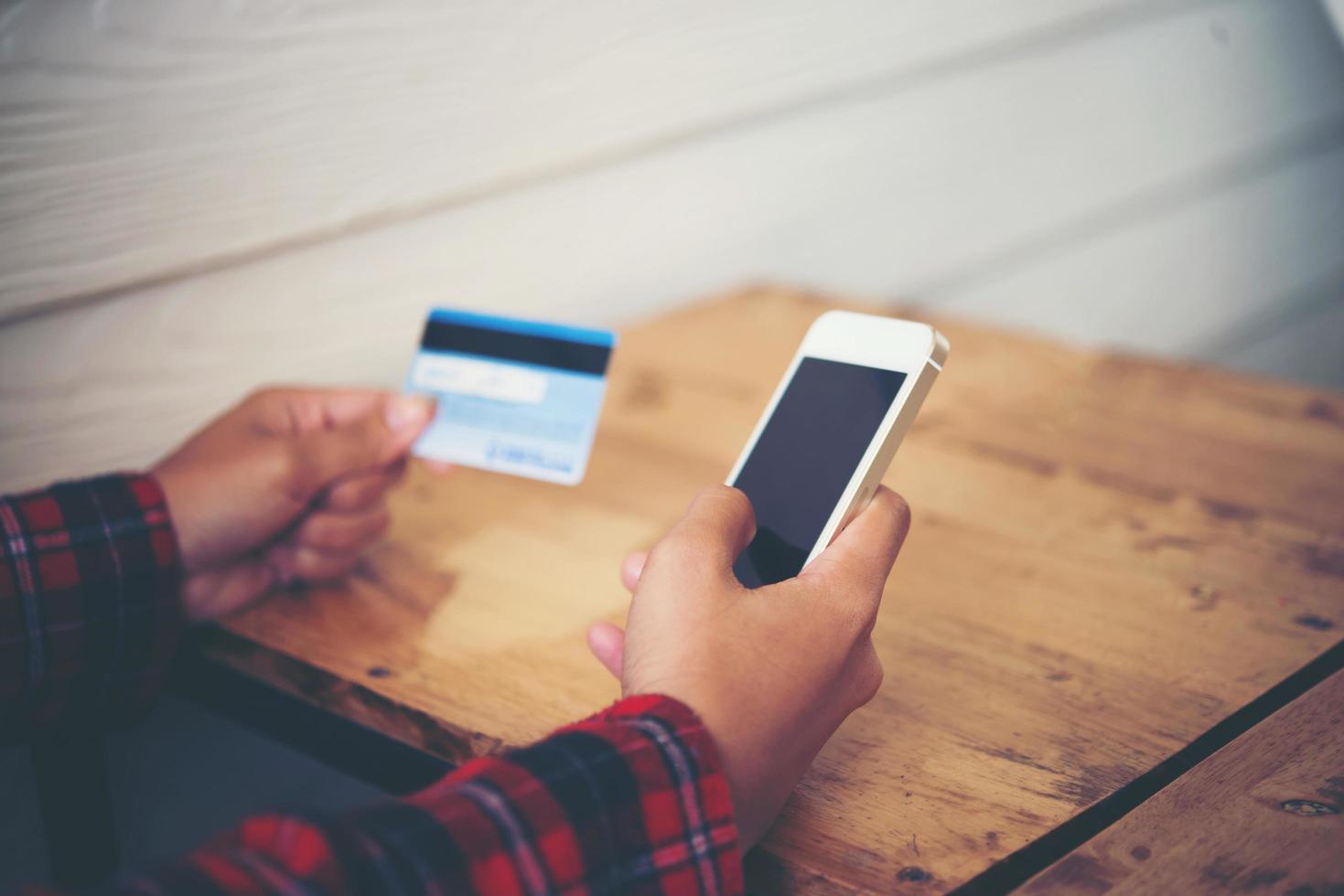 Hipster woman shopping online while relaxing in a cafe photo