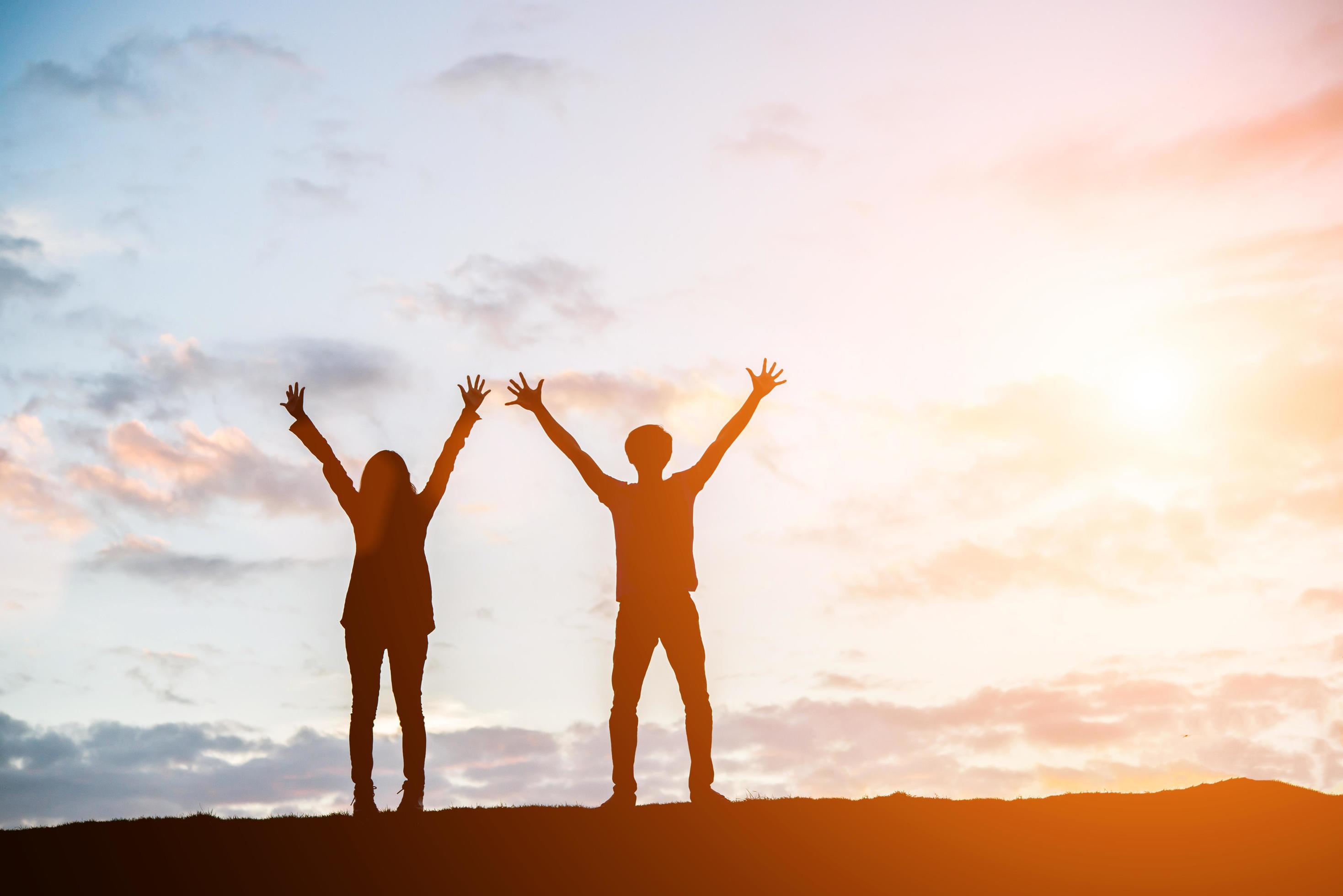 Silhouette of happy young couple together against beautiful sunset ...