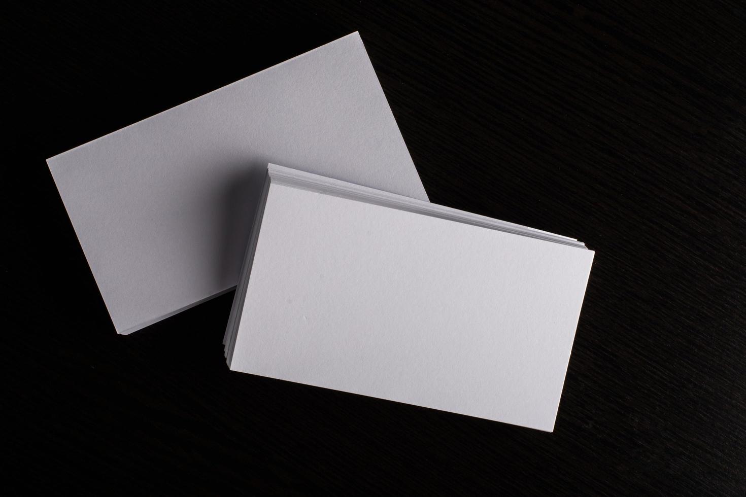 Blank white business card on wood background photo