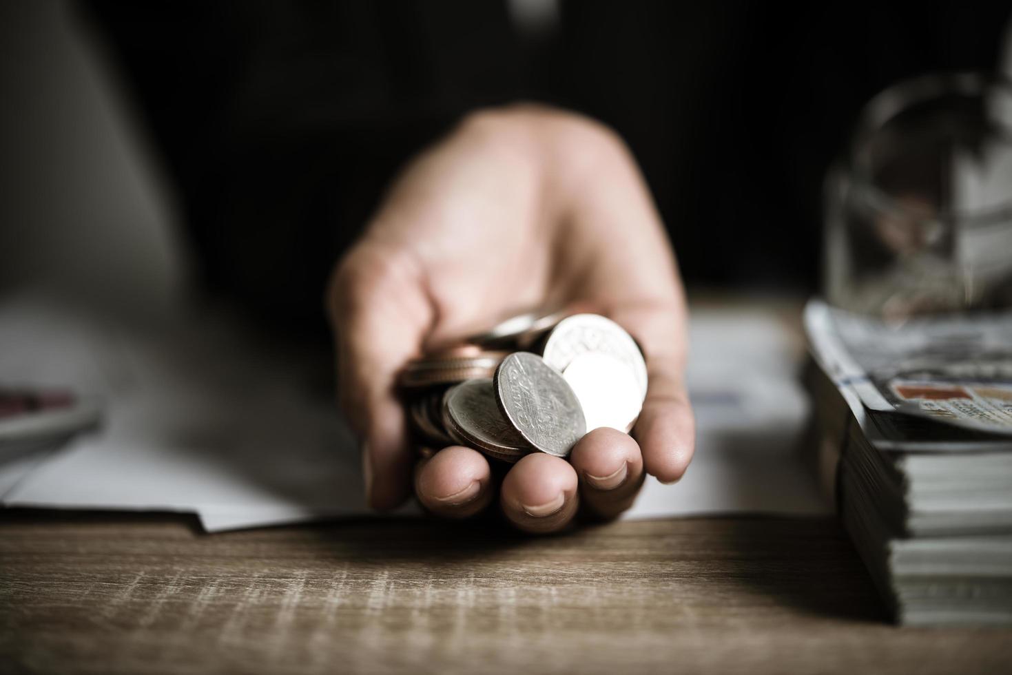 Silver coins in hands photo