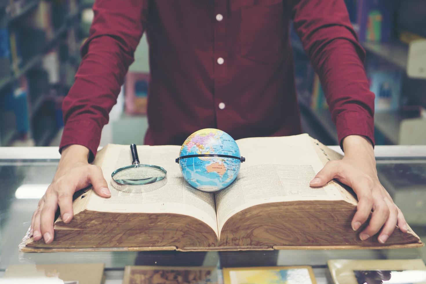 Young student holding earth model in hand photo