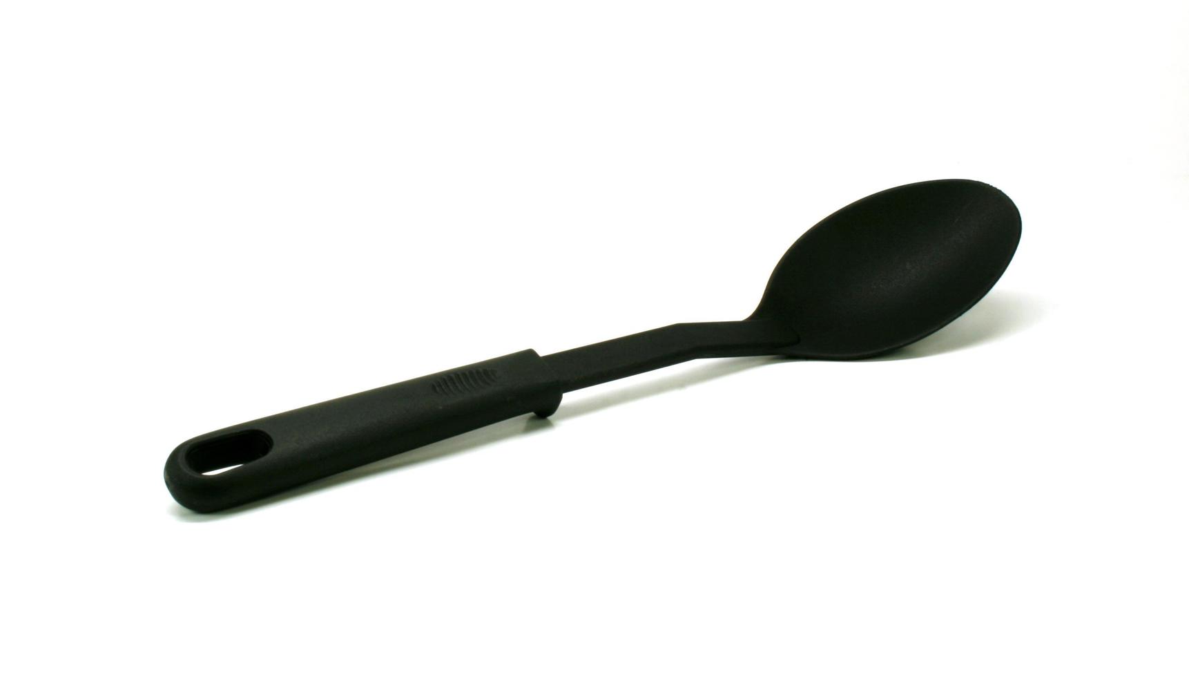 Black plastic ladle on white photo