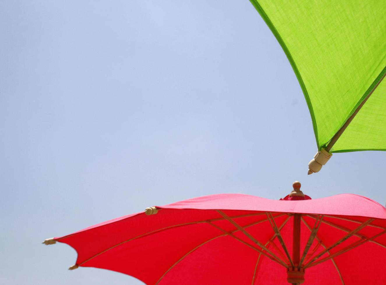 Two umbrellas and blue sky photo