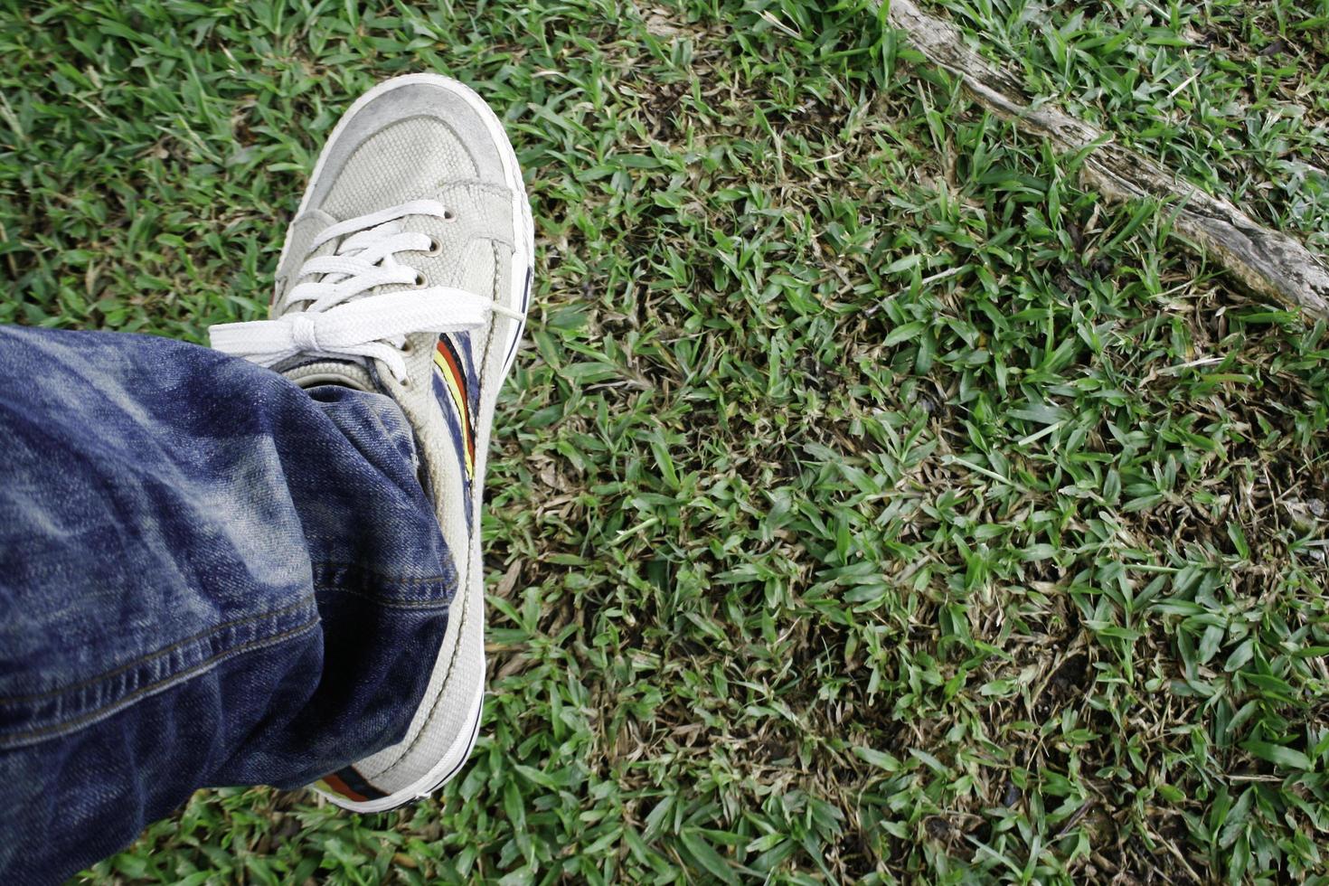 Person stepping on grass photo