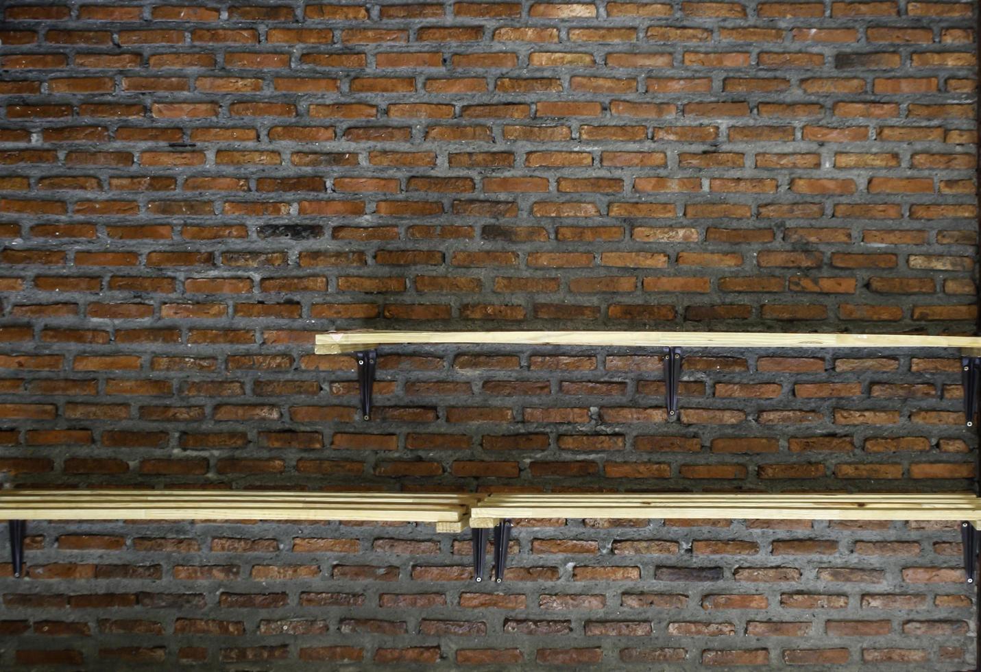 Shelves on brick wall photo