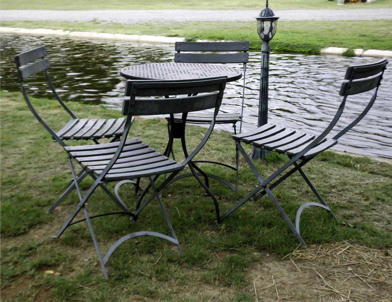 Table and chairs near lake photo