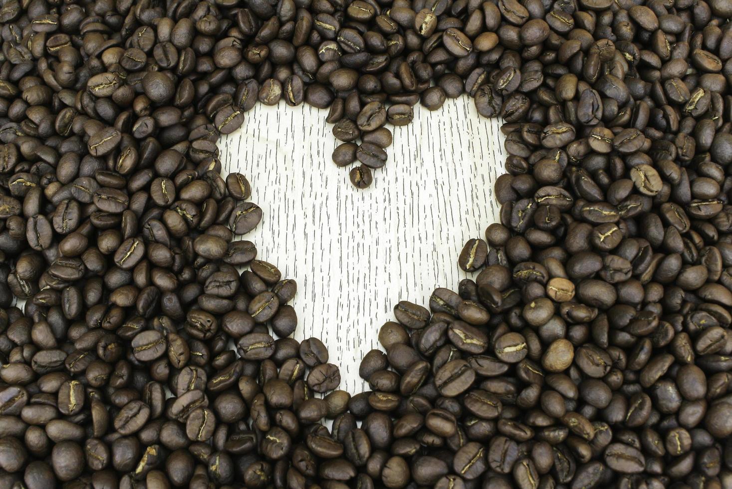 Heart shape made from coffee beans photo