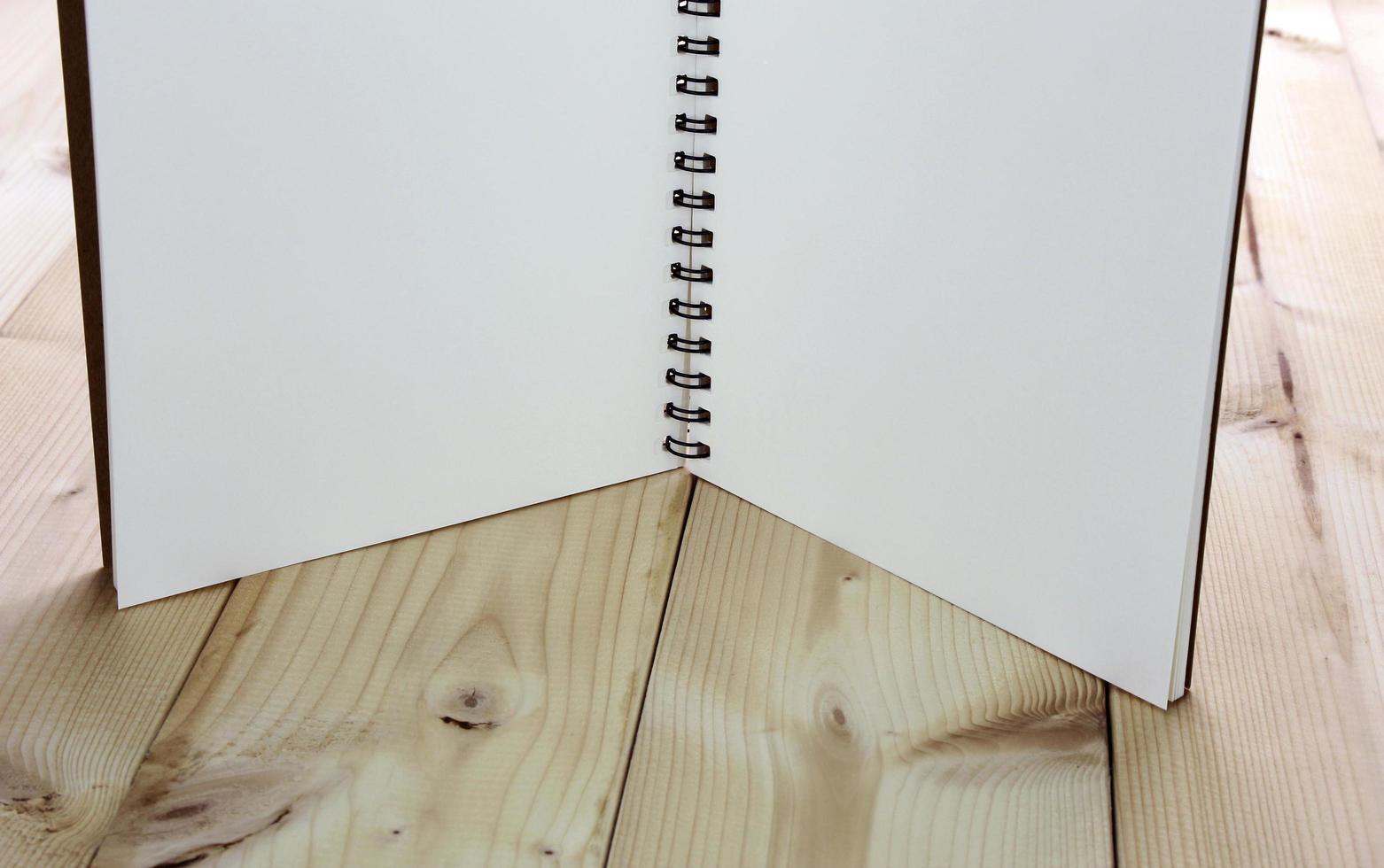 Open notebook standing on table photo