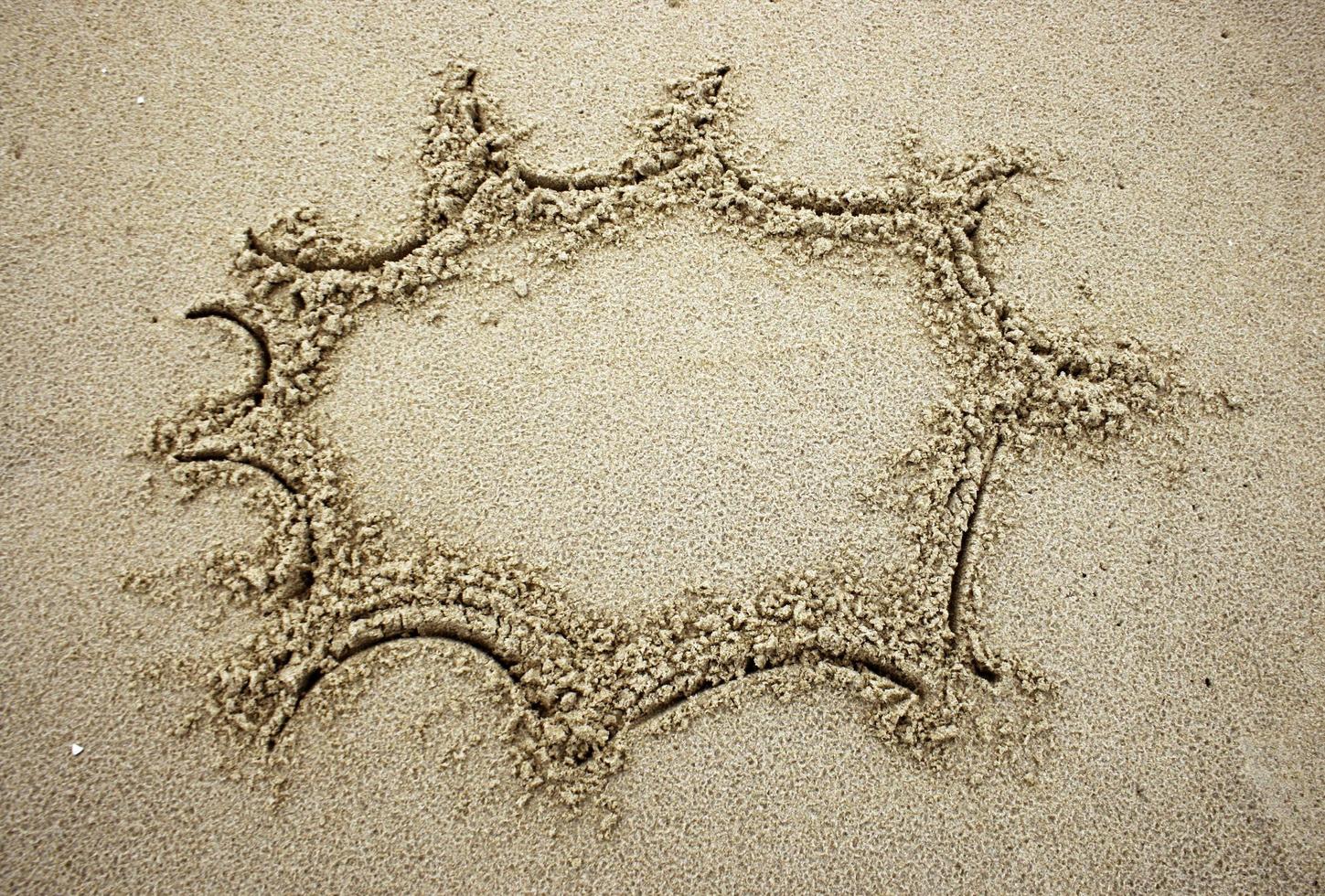 Sun drawn in sand photo