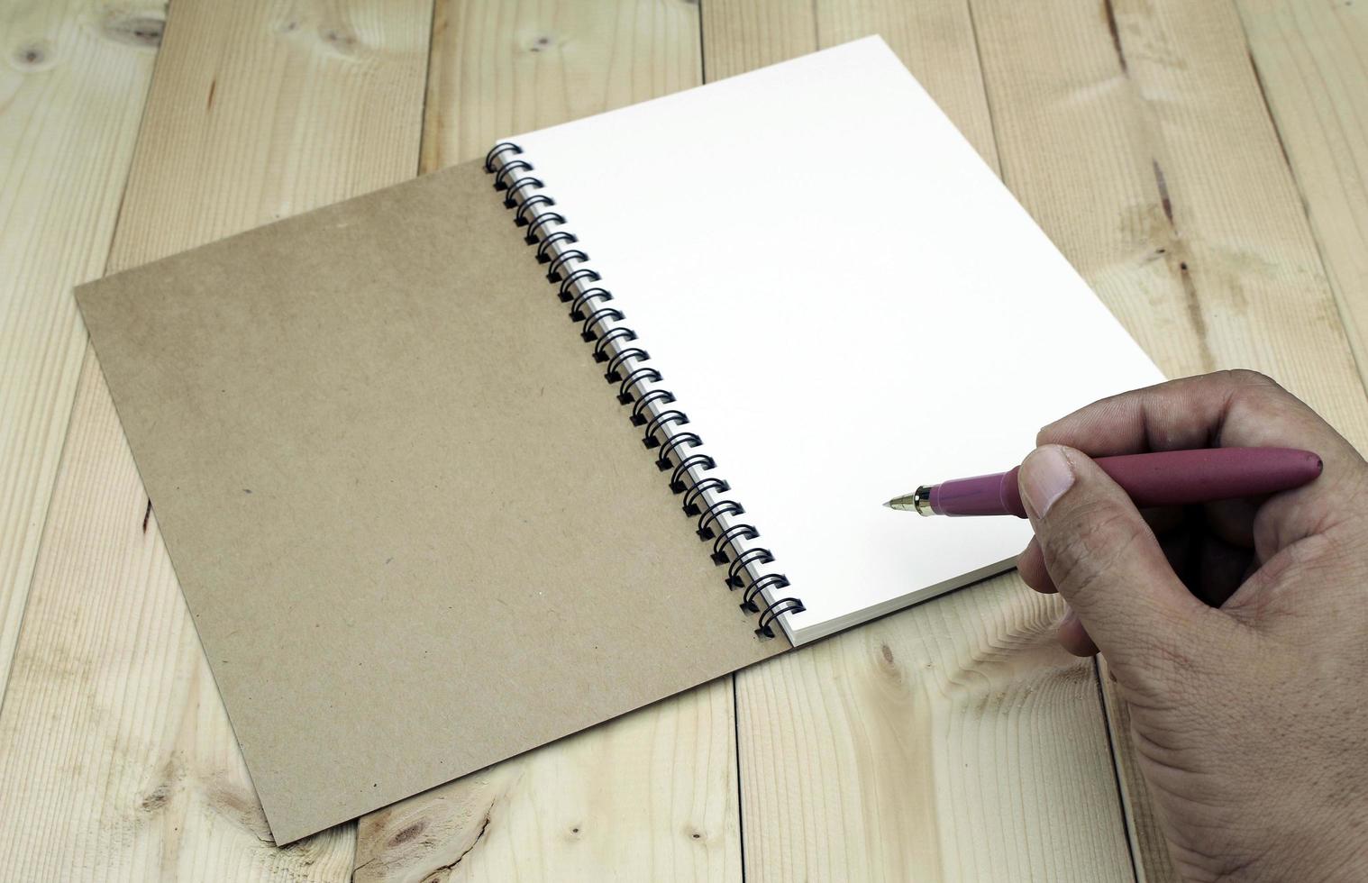 Person writing in notebook photo