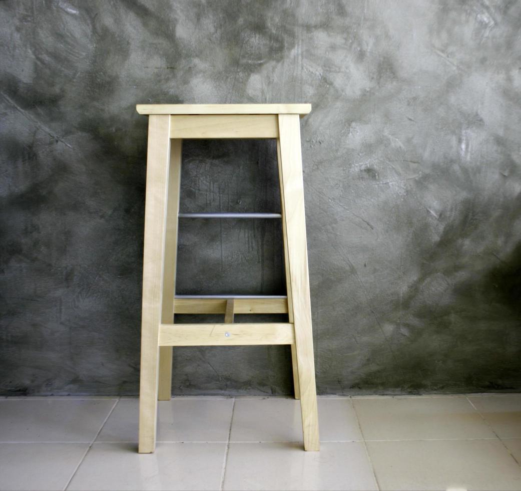 Wood stool on gray background photo