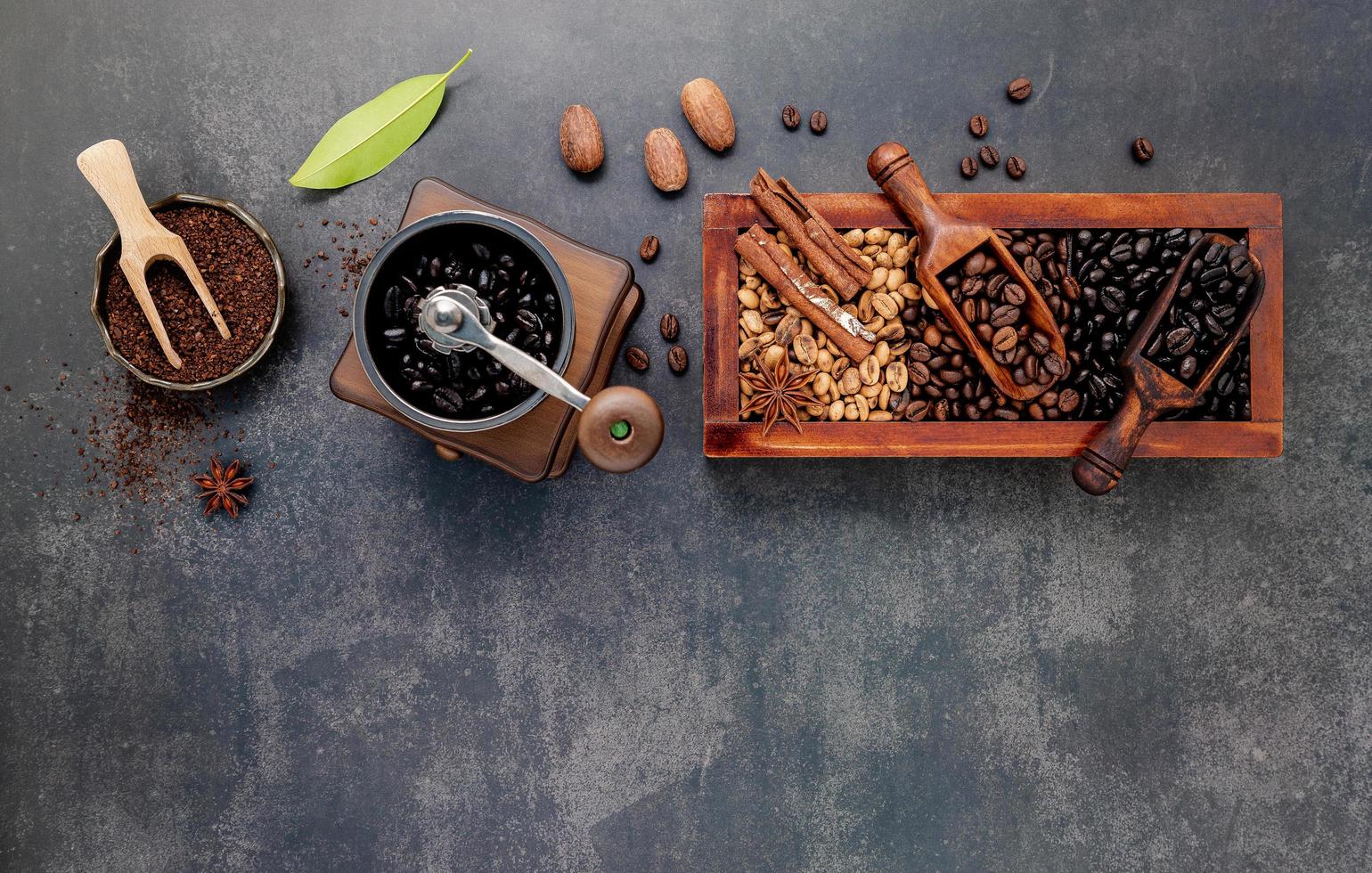 Roasted coffee beans with scoop with manual grinder photo