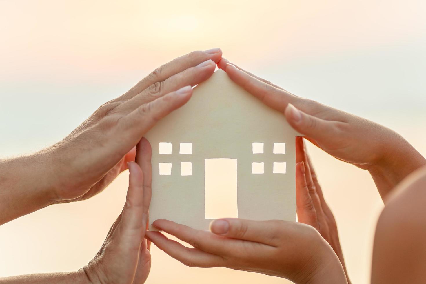 People holding a house photo