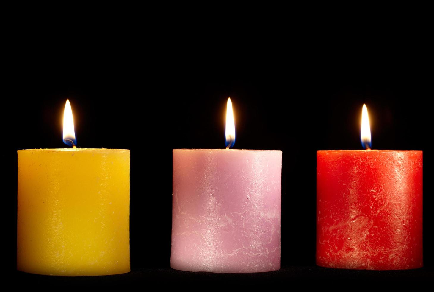 Three candles on black photo