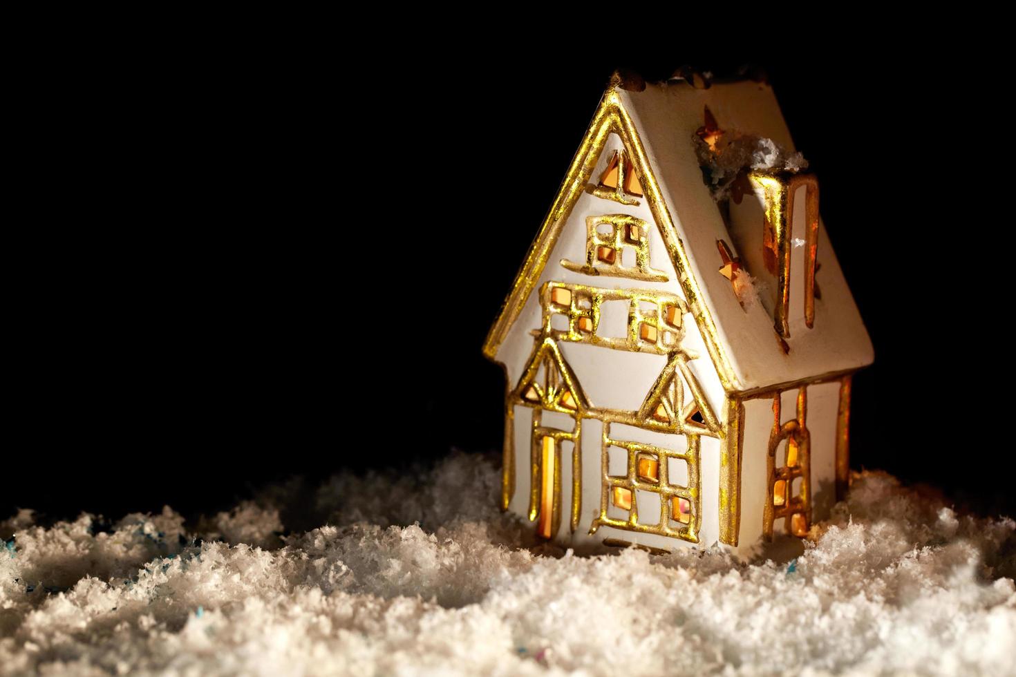 Gold and silver decorative house in snow photo